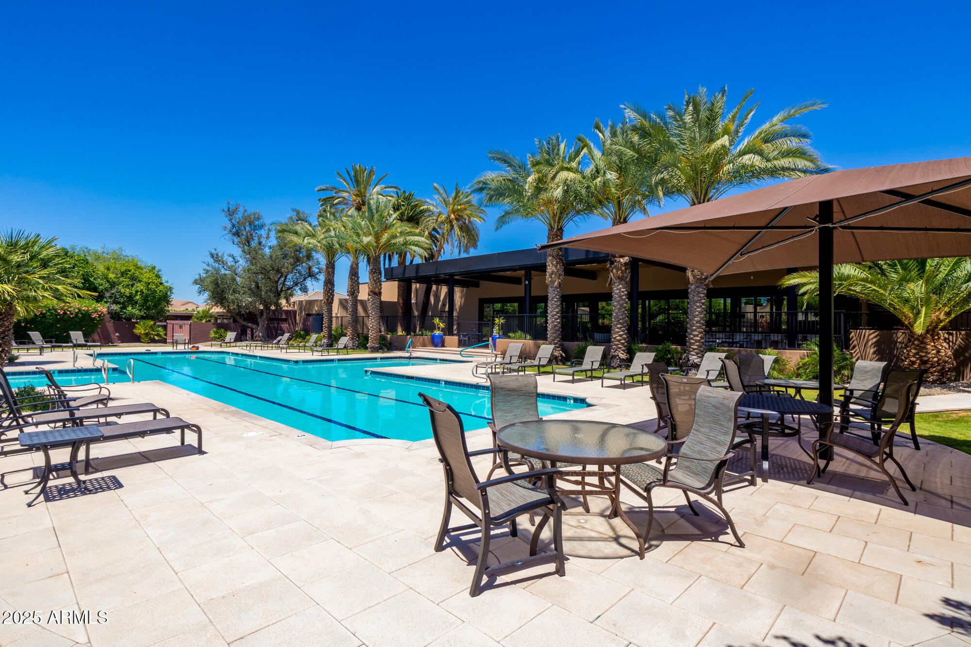 7700 East Gainey Ranch Road, Unit 125 Scottsdale, AZ 85258 - Photo 40 of 46 a swimming pool with outdoor seating and yard
