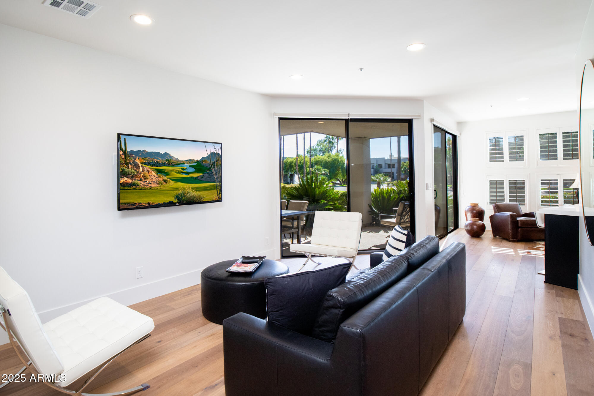 7700 East Gainey Ranch Road, Unit 125 Scottsdale, AZ 85258 - Photo 7 of 46 a living room with furniture and floor to ceiling windows
