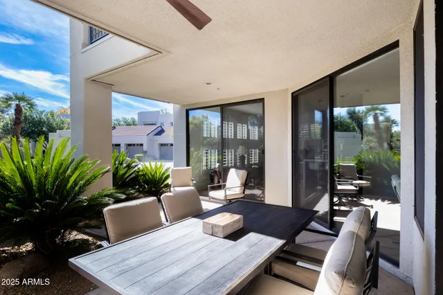 a living room with furniture potted plant and a large window