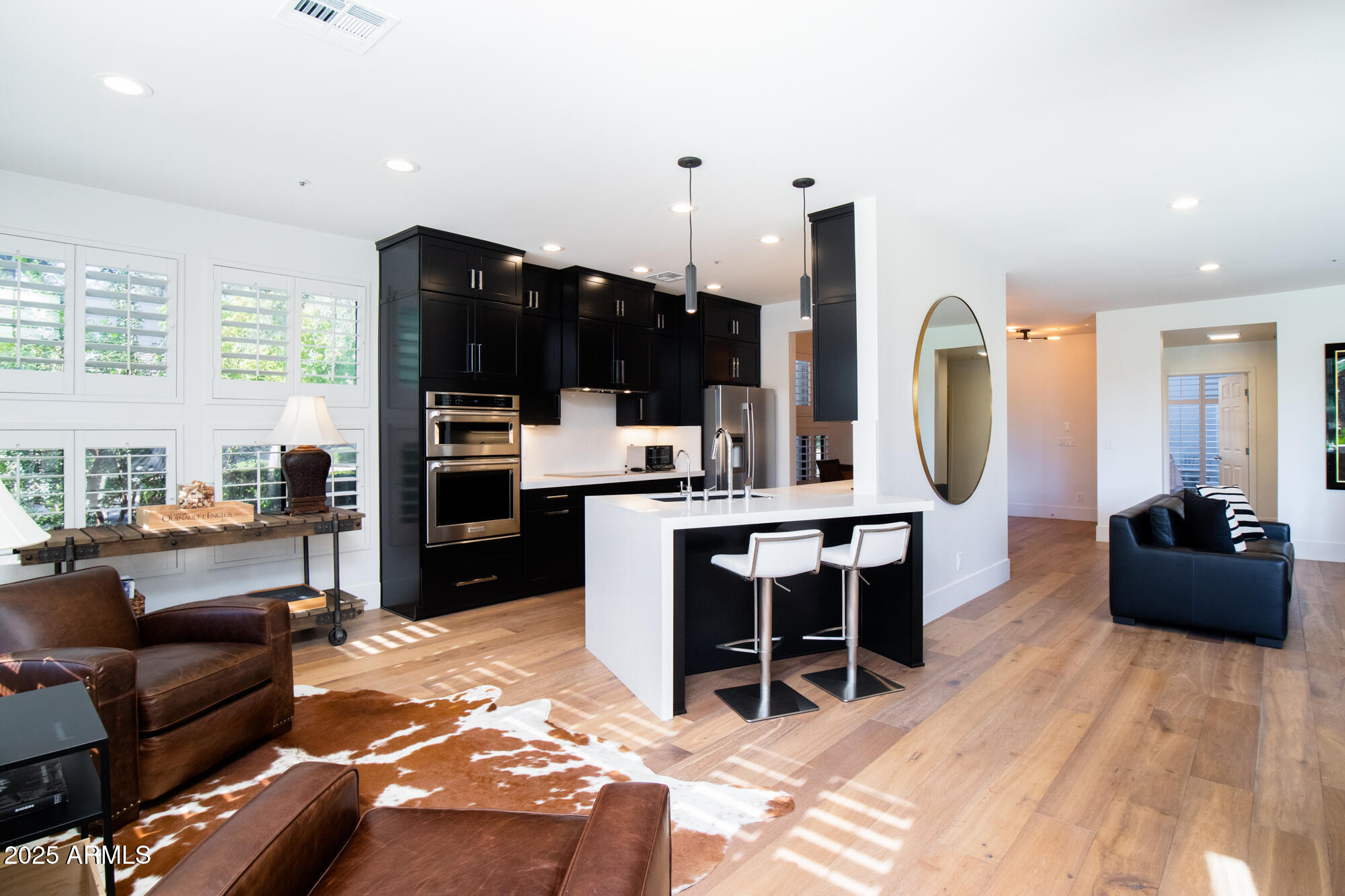 7700 East Gainey Ranch Road, Unit 125 Scottsdale, AZ 85258 - Photo 10 of 46 a living room with furniture a flat screen tv and kitchen view
