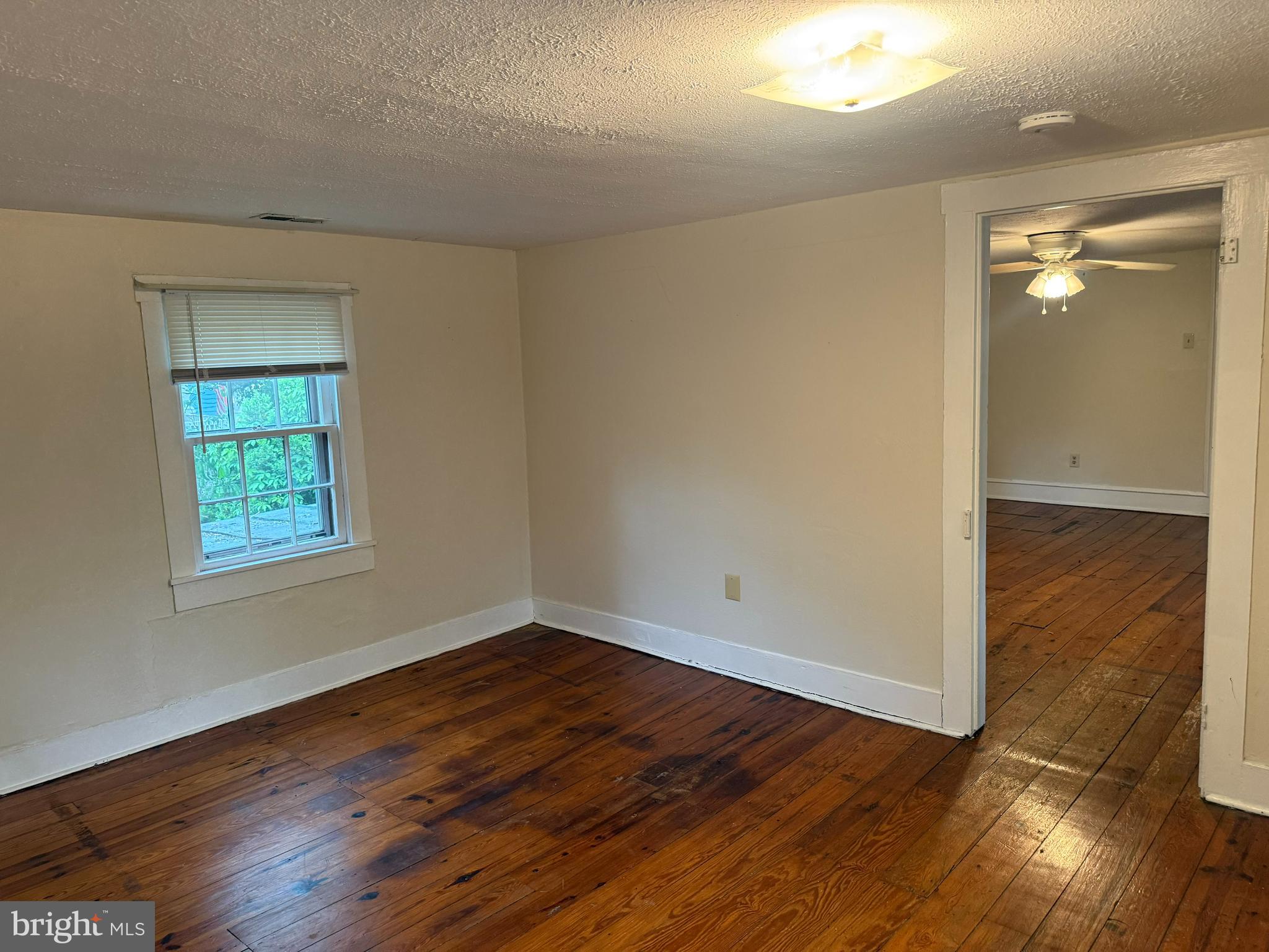 619 South Cameron Street, Unit 2 Winchester, VA 22601 - Photo 3 of 7 an empty room with wooden floor and windows