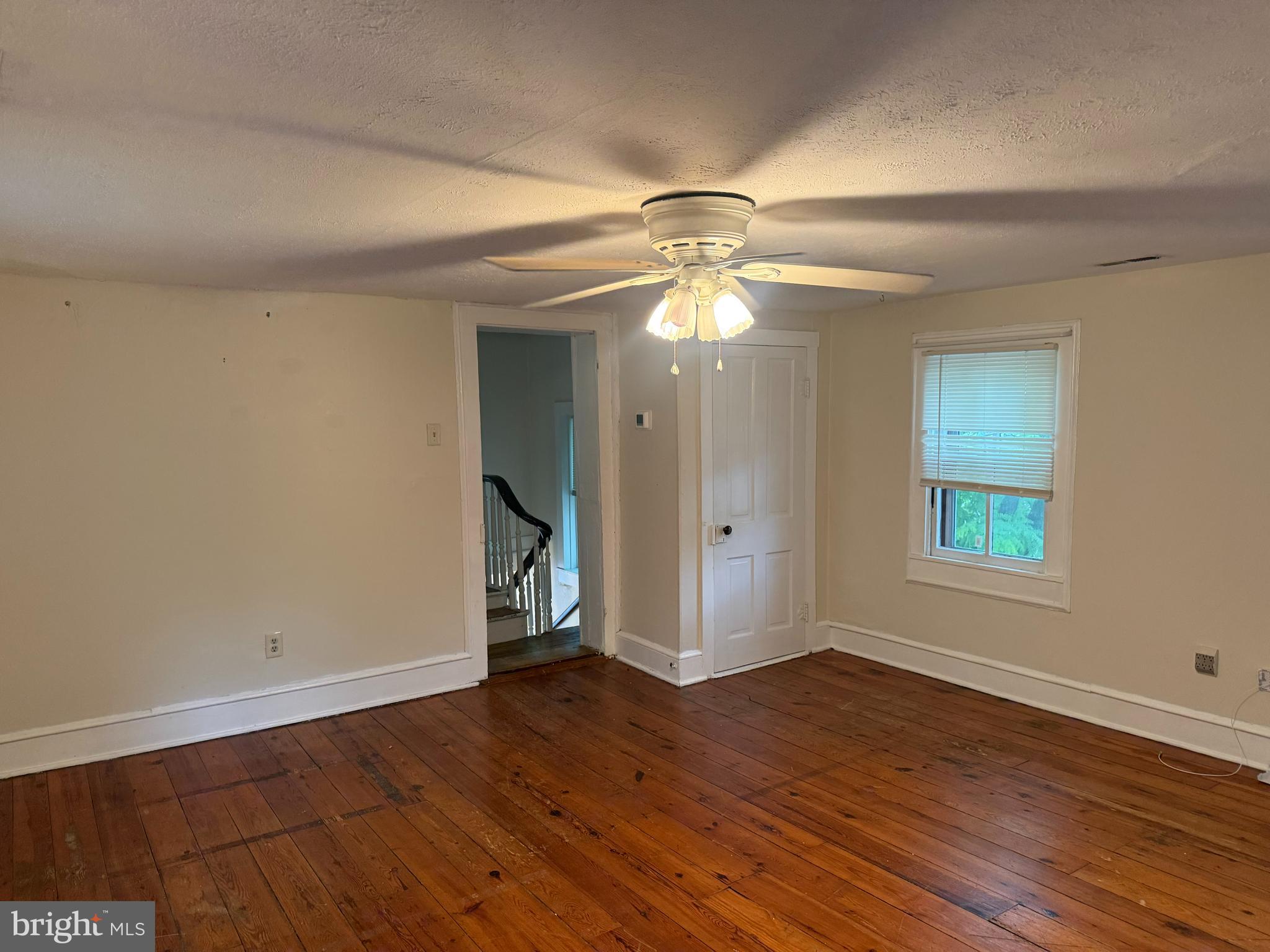 619 South Cameron Street, Unit 2 Winchester, VA 22601 - Photo 4 of 7 an empty room with wooden floor and windows