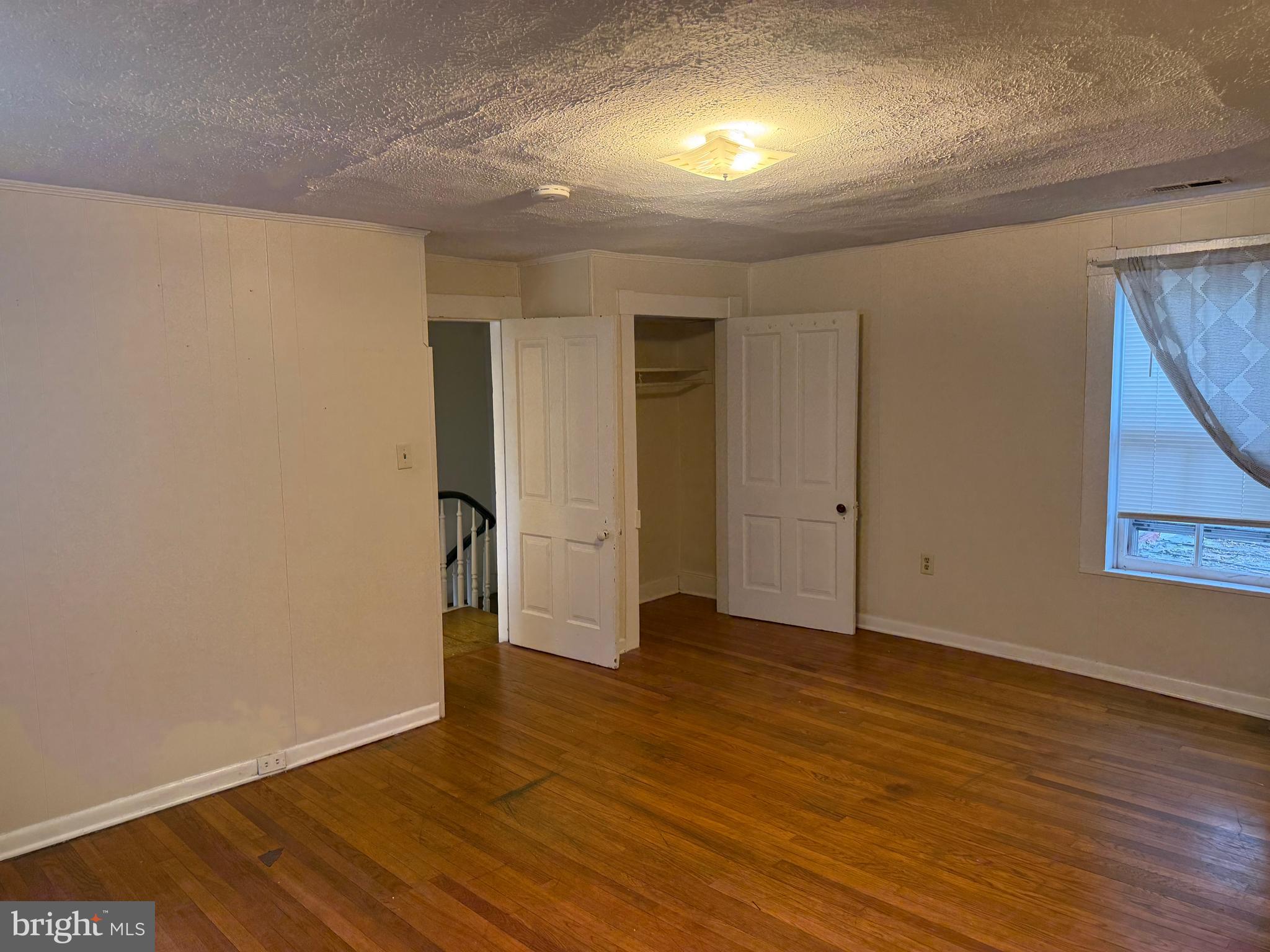 619 South Cameron Street, Unit 2 Winchester, VA 22601 - Photo 6 of 7 an empty room with wooden floor and windows