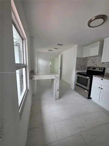 a view of a kitchen with furniture and windows