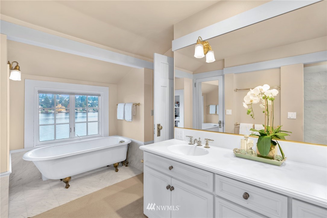 3808 Hunts Point Road Hunts Point, WA 98004 - Photo 14 of 24 a spacious bathroom with a double vanity sink and a mirror