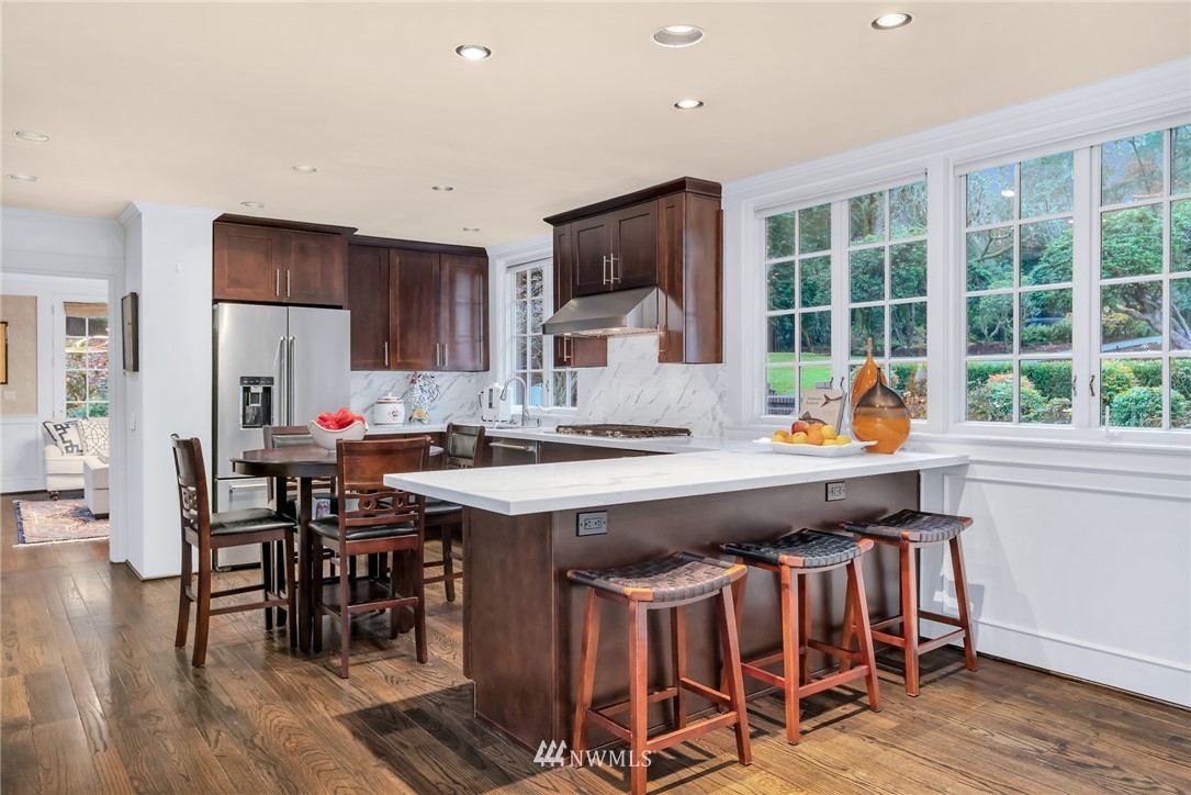3808 Hunts Point Road Hunts Point, WA 98004 - Photo 20 of 24 a kitchen with a sink and chairs