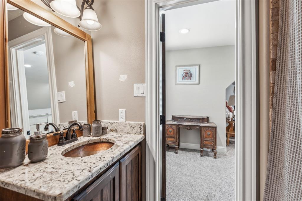 4180 North Smith Road Fate, TX 75087 - Photo 24 of 27 a en suite bathroom with a granite countertop sink and a mirror