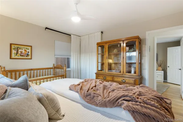a bedroom with a large bed and a large window