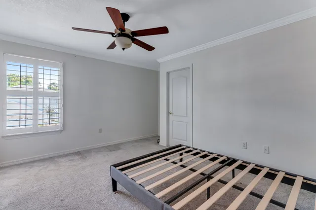 a view of room with window and ceiling fan