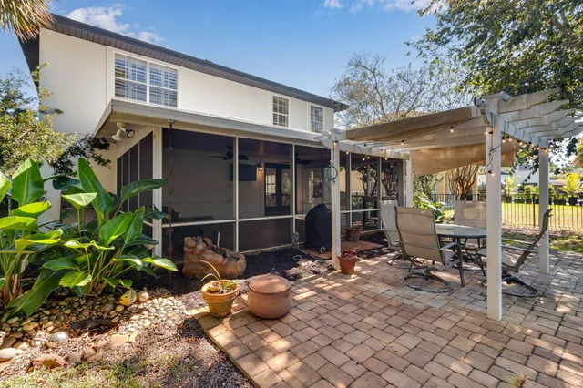 a view of a chairs and table in backyard of the house