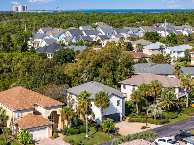 an aerial view of residential houses with outdoor space and street view