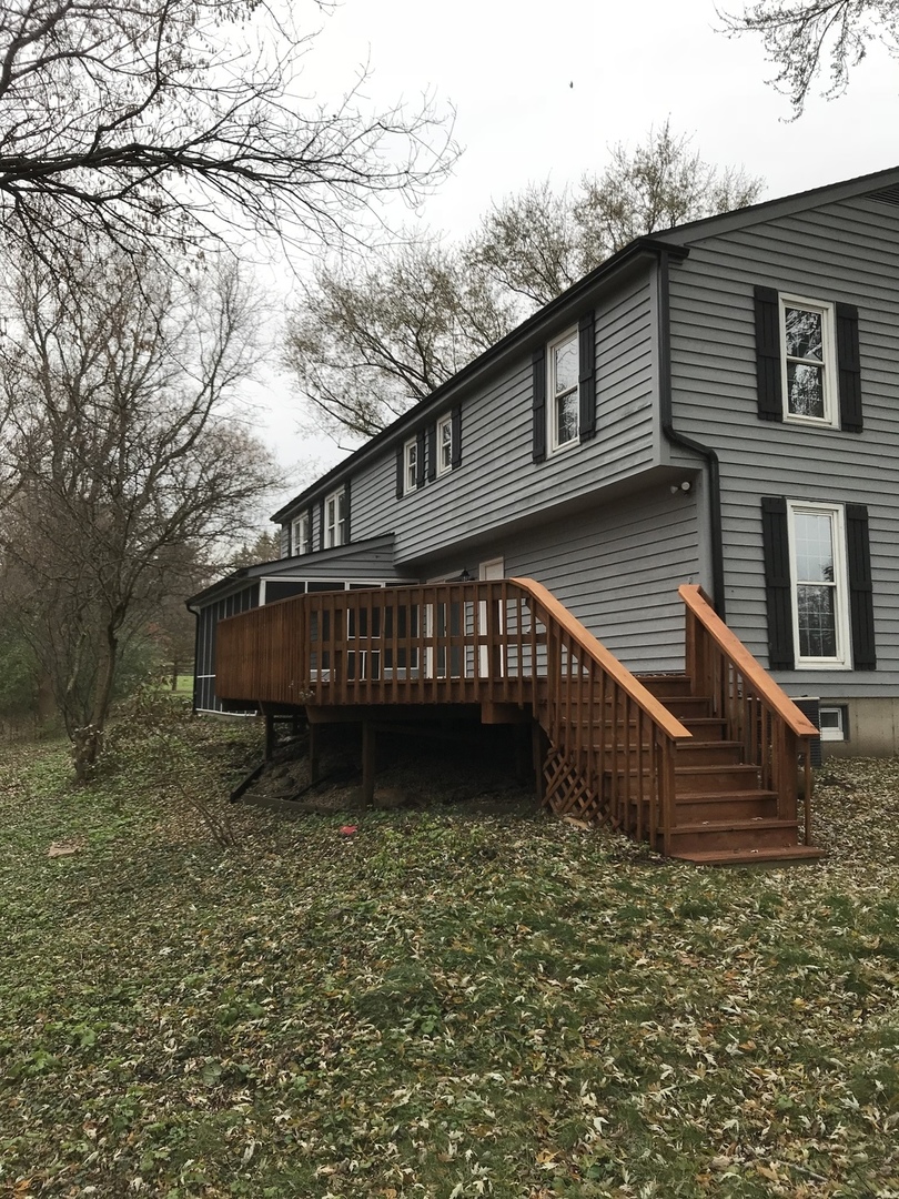 2704 South Red Barn Road Crystal Lake, IL 60012 - Photo 15 of 17 a view of a house with wooden fence