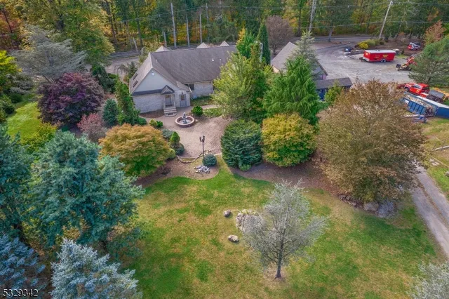 a backyard of a house with a yard and outdoor seating