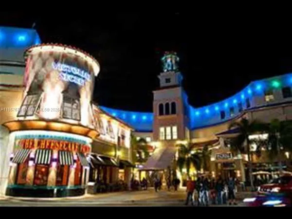 a vase of flowers sitting on a table with a potted plants