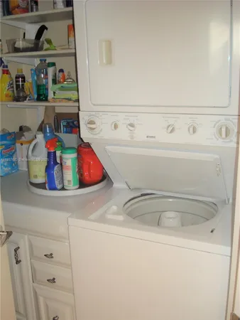 a kitchen with stainless steel appliances granite countertop a refrigerator a stove and a sink with wooden floor