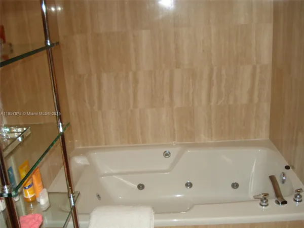 a bedroom with a bed and a lamp on table