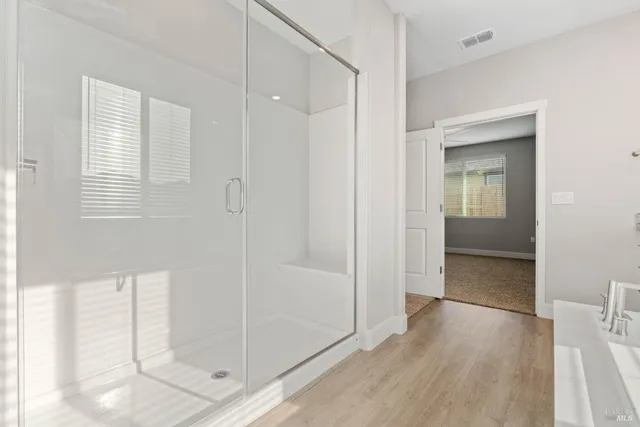 a bathroom with a glass shower door