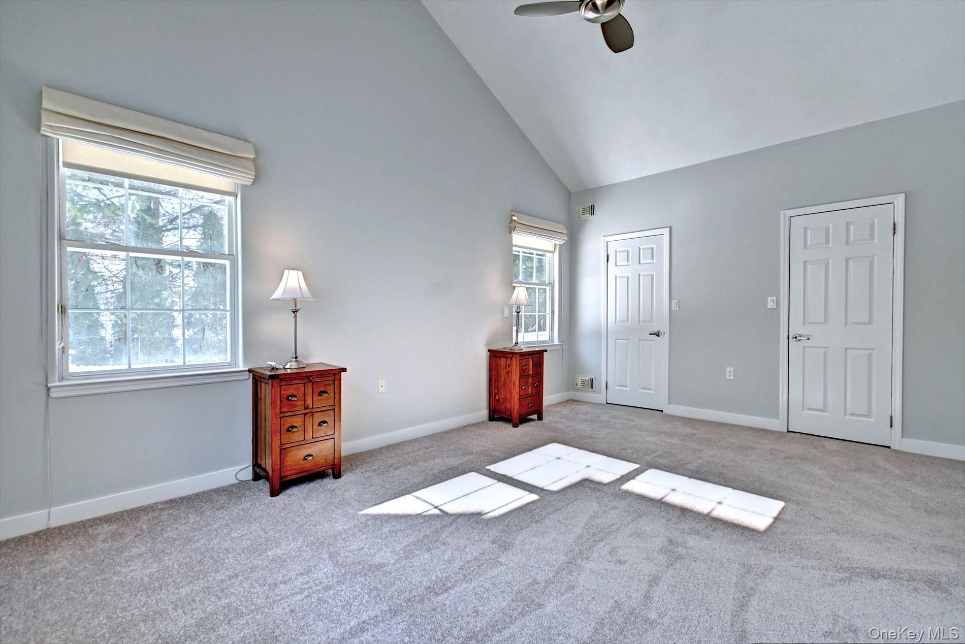 530 Leisure Drive Ridge, NY 11961 - Photo 15 of 26 Primary Bedroom with Cathedral Ceiling, Fan & Lots of Sunshine