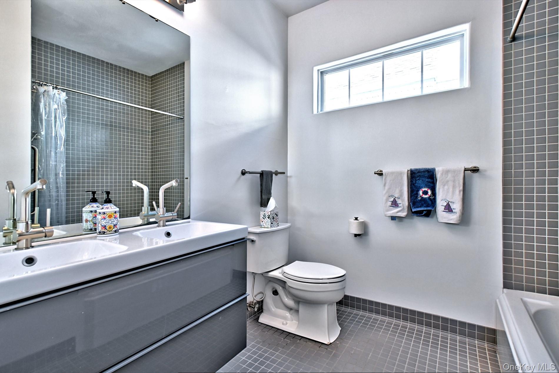 530 Leisure Drive Ridge, NY 11961 - Photo 21 of 26 Totally Updated Guest Bath with Tub and Custom Tile