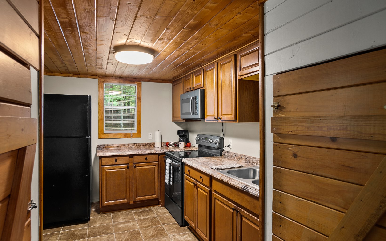 12 Rose Court Ellijay, GA 30540 - Photo 9 of 34 a kitchen with a sink and a refrigerator