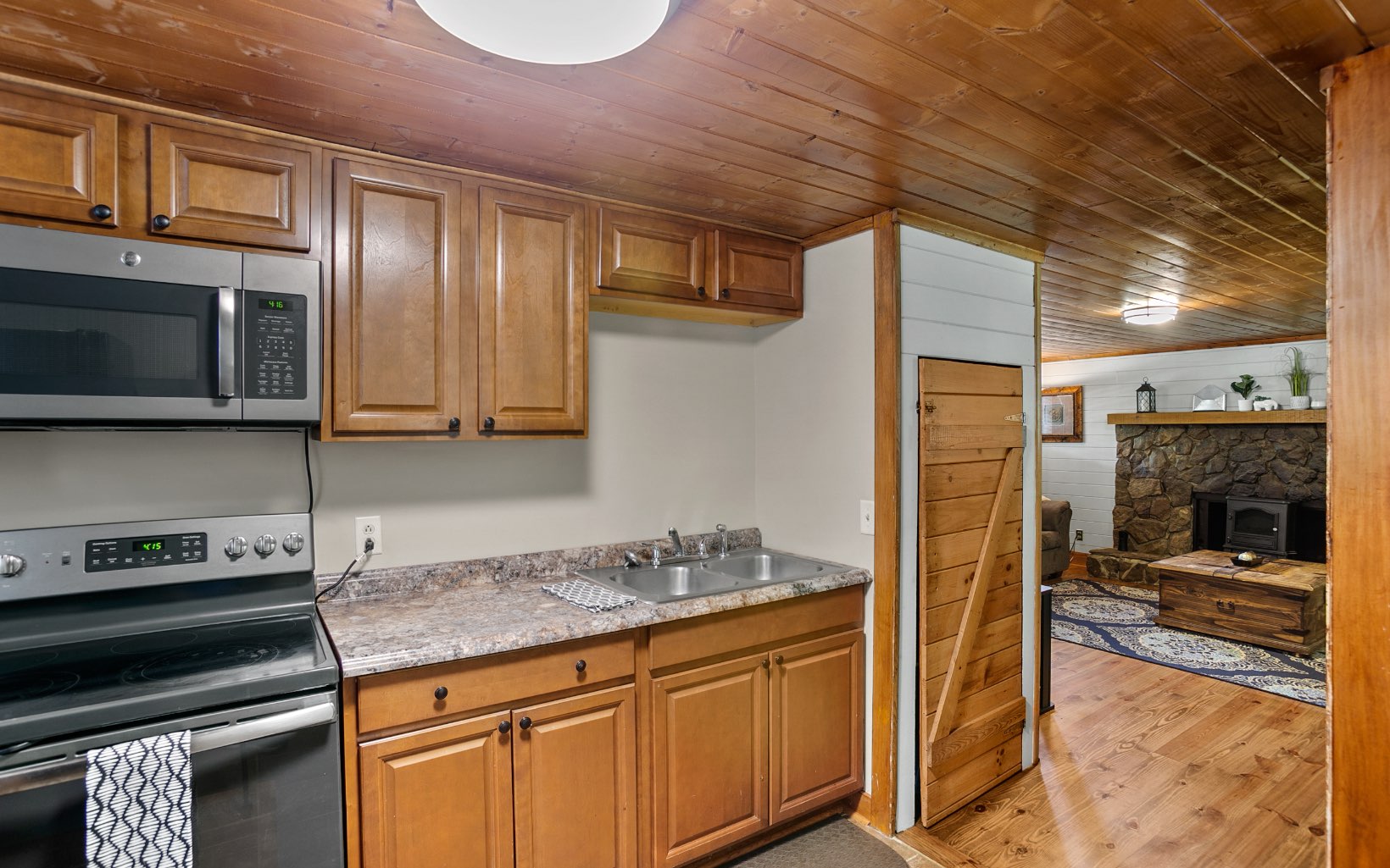 12 Rose Court Ellijay, GA 30540 - Photo 10 of 34 a kitchen with stainless steel appliances granite countertop a stove a sink and a microwave
