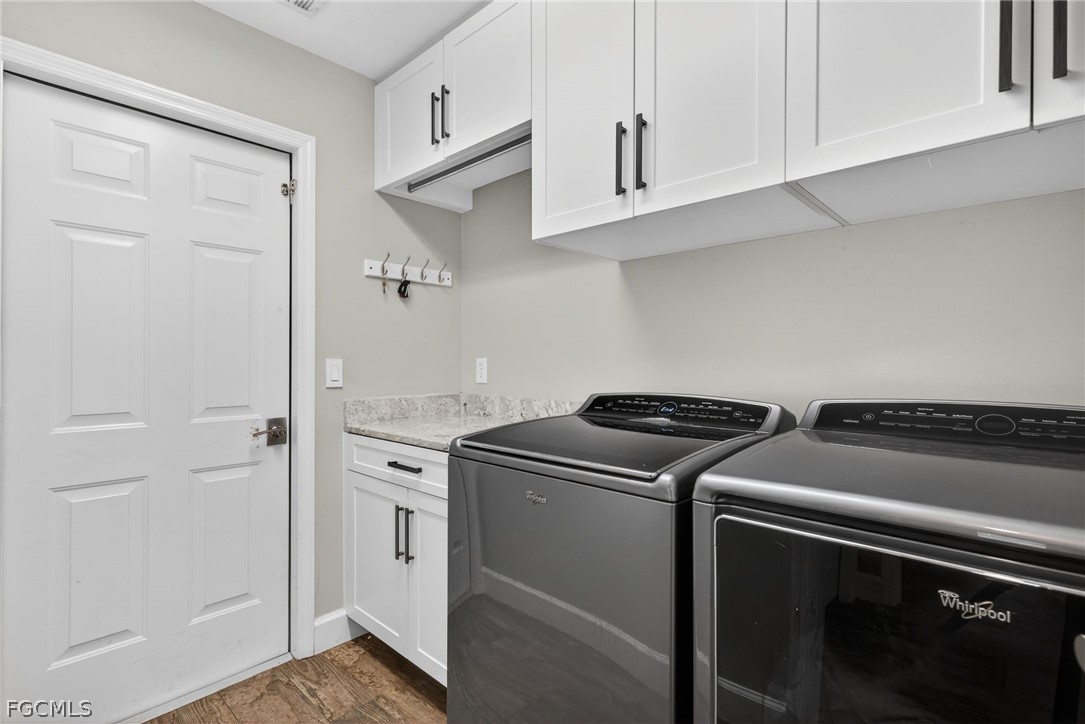 22866 Forest Ridge Drive Estero, FL 33928 - Photo 28 of 38 a view of a kitchen with washer and dryer