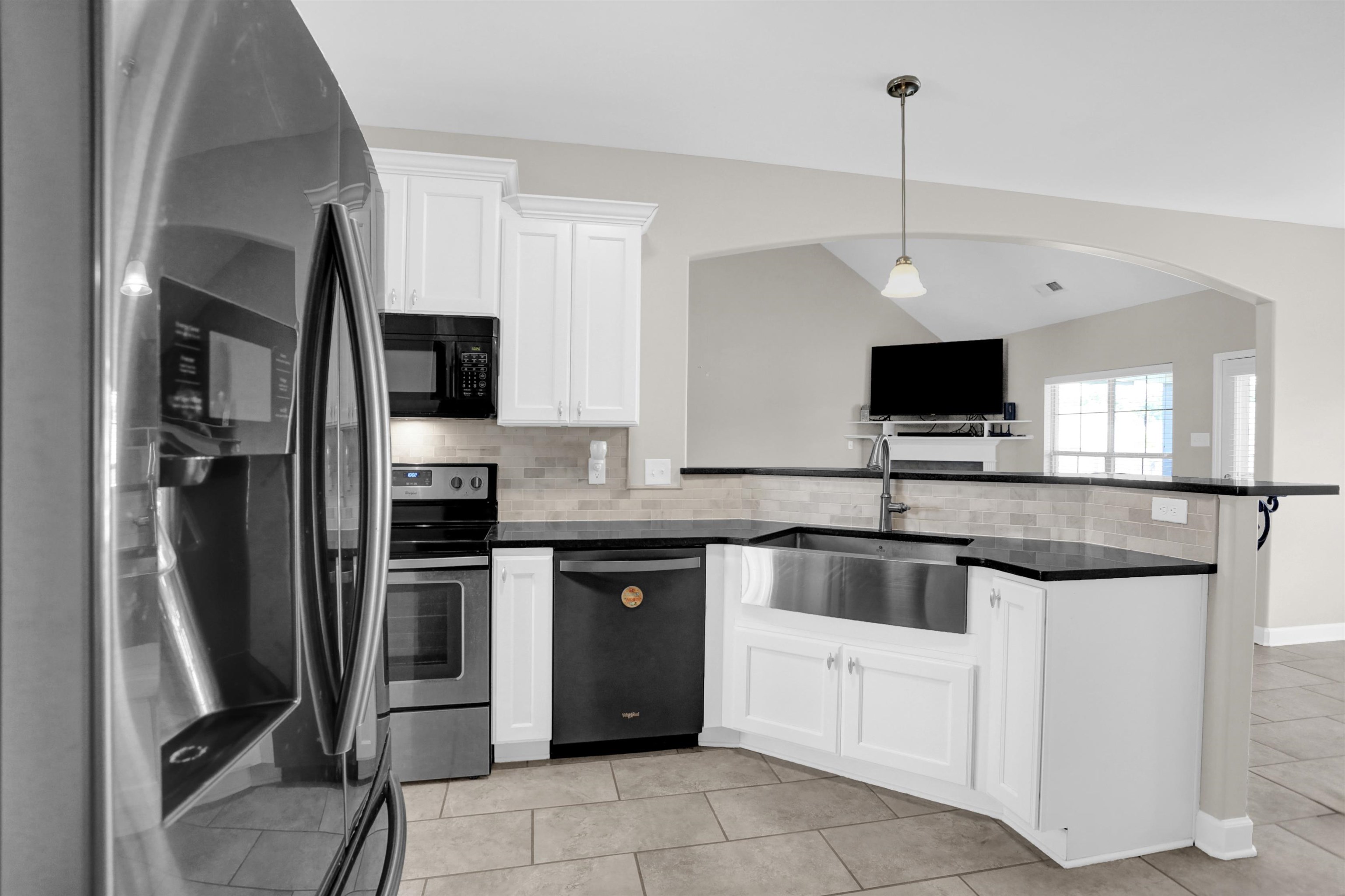 25 Breezy Loop Oakland, TN 38060 - Photo 5 of 19 a kitchen with stainless steel appliances granite countertop a sink and a refrigerator
