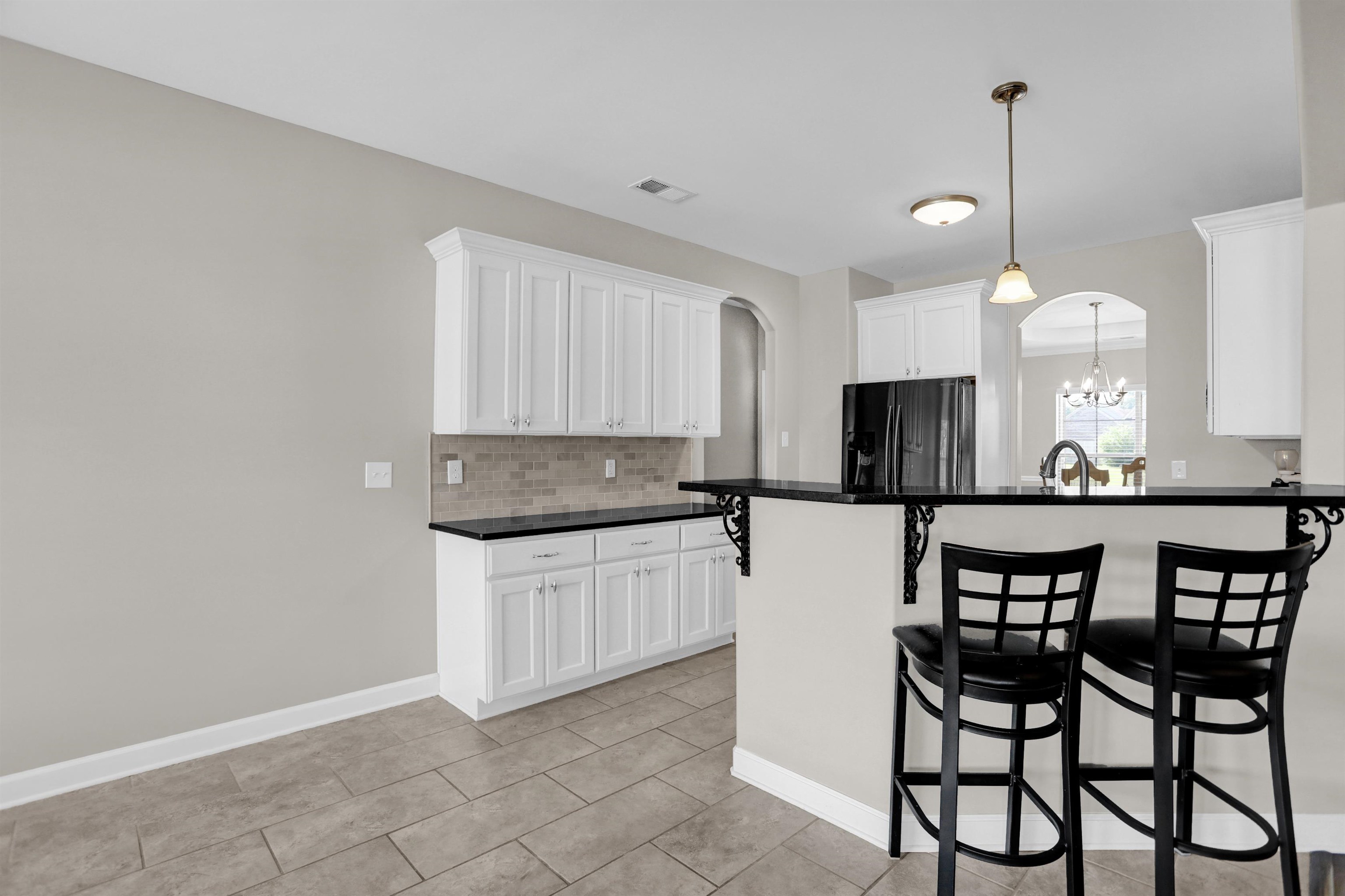 25 Breezy Loop Oakland, TN 38060 - Photo 6 of 19 a kitchen with stainless steel appliances granite countertop a stove top oven a sink with a dining table and chairs