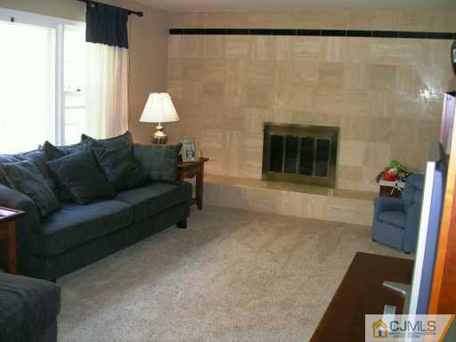 21 Thomas Road East Brunswick, NJ 08816 - Photo 3 of 8 a living room with furniture and a fireplace