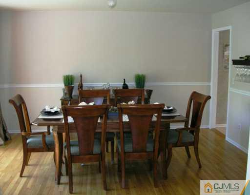 21 Thomas Road East Brunswick, NJ 08816 - Photo 6 of 8 a view of a dining room with furniture and wooden floor