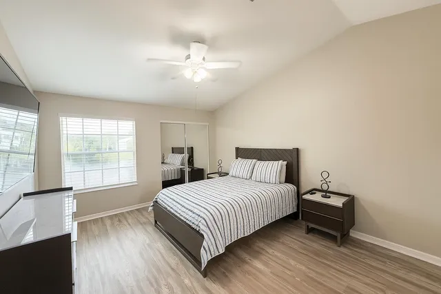a bedroom with a large bed and a window