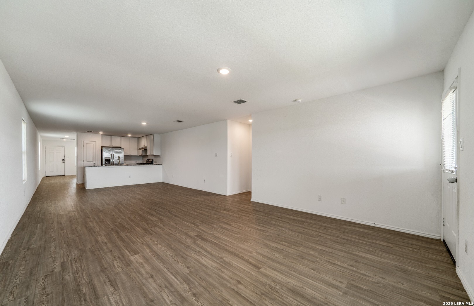 6566 Runaway Row Converse, TX 78109 - Photo 8 of 27 a view of empty room with wooden floor