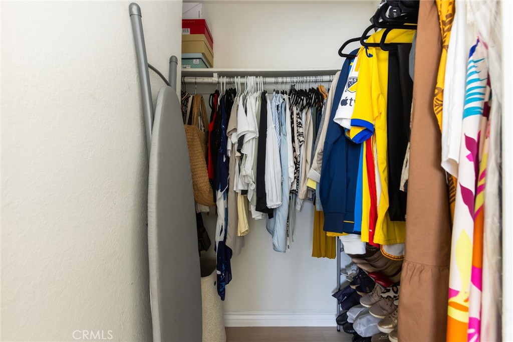 726 Elm Avenue, Unit 404 Long Beach, CA 90813 - Photo 28 of 31 a view of walk in closet with clothes and shoes