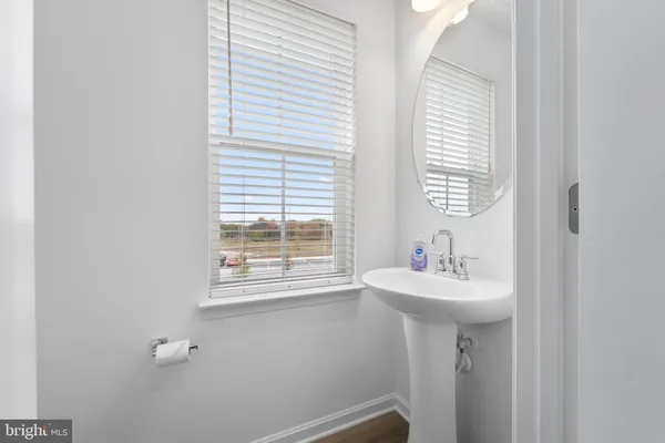 a bathroom with a sink a window and a mirror