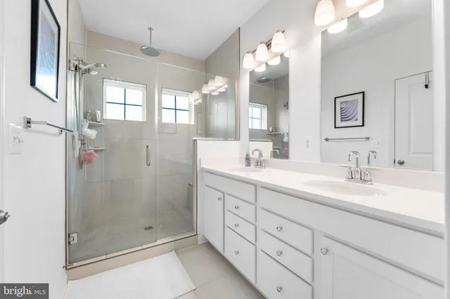 a bathroom with a shower sink and mirror