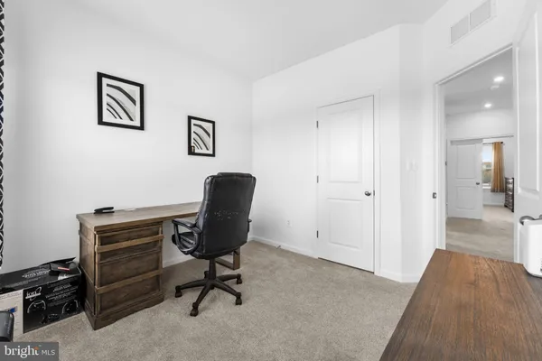 a view of a workspace with furniture and a bedroom