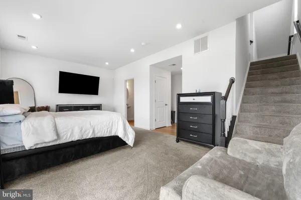 a bedroom with a bed and a television