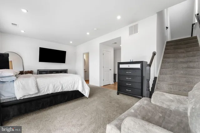 a bedroom with a bed and a television