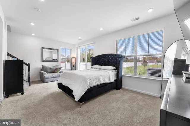 a bedroom with a large bed and a large window