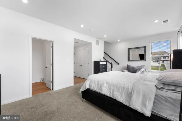 a bedroom with a large bed and a flat screen tv