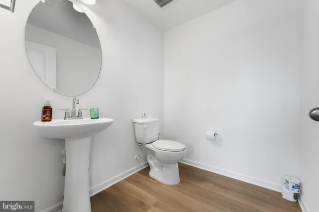 a bathroom with a sink toilet and a mirror