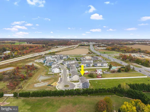 an aerial view of residential building with outdoor space swimming pool and ocean view