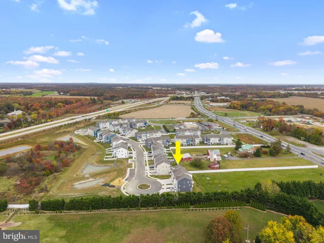 an aerial view of residential building with outdoor space swimming pool and ocean view