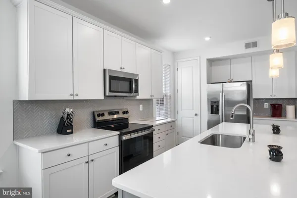 a kitchen with a sink a stove and refrigerator