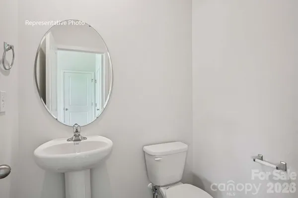 a bathroom with a toilet a sink and a mirror