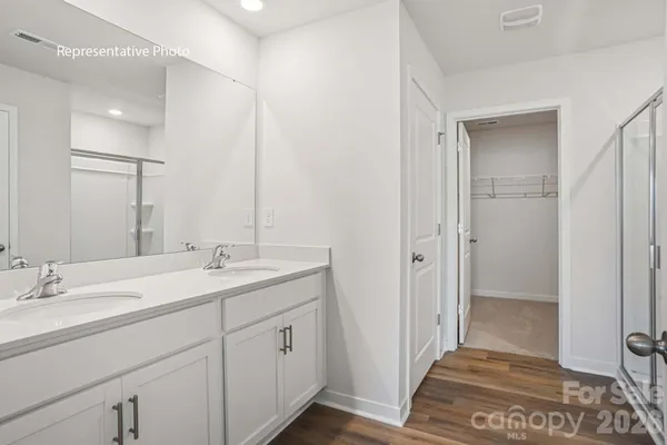 a bathroom with a glass shower door