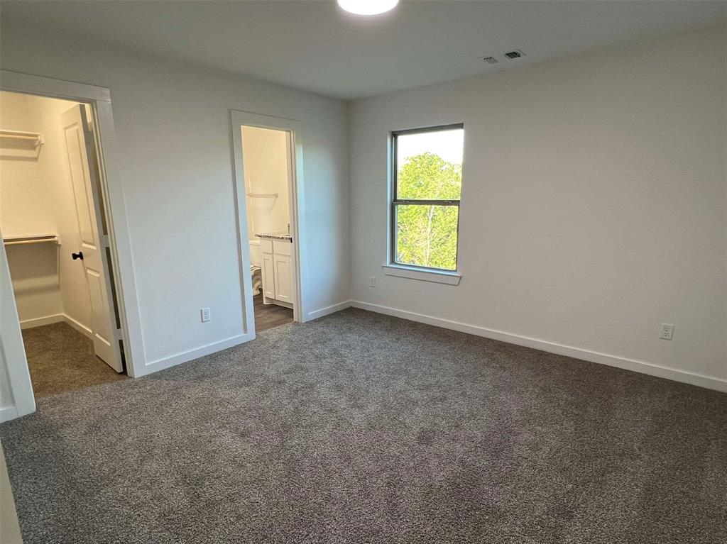 2526 South Fannin Avenue Denison, TX 75020 - Photo 11 of 20 an empty room with a window and a bathroom
