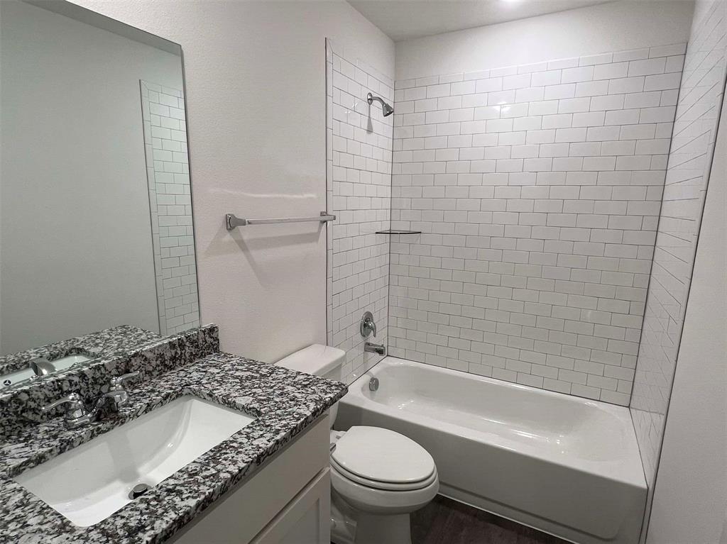 2526 South Fannin Avenue Denison, TX 75020 - Photo 13 of 20 a bathroom with a granite countertop sink toilet and shower