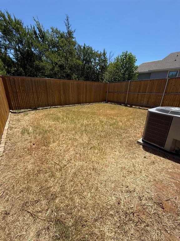 2526 South Fannin Avenue Denison, TX 75020 - Photo 20 of 20 a view of a backyard with wooden fence