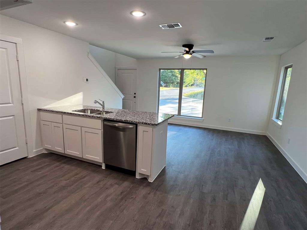 2526 South Fannin Avenue Denison, TX 75020 - Photo 8 of 20 a kitchen with granite countertop a sink a window and wooden floor